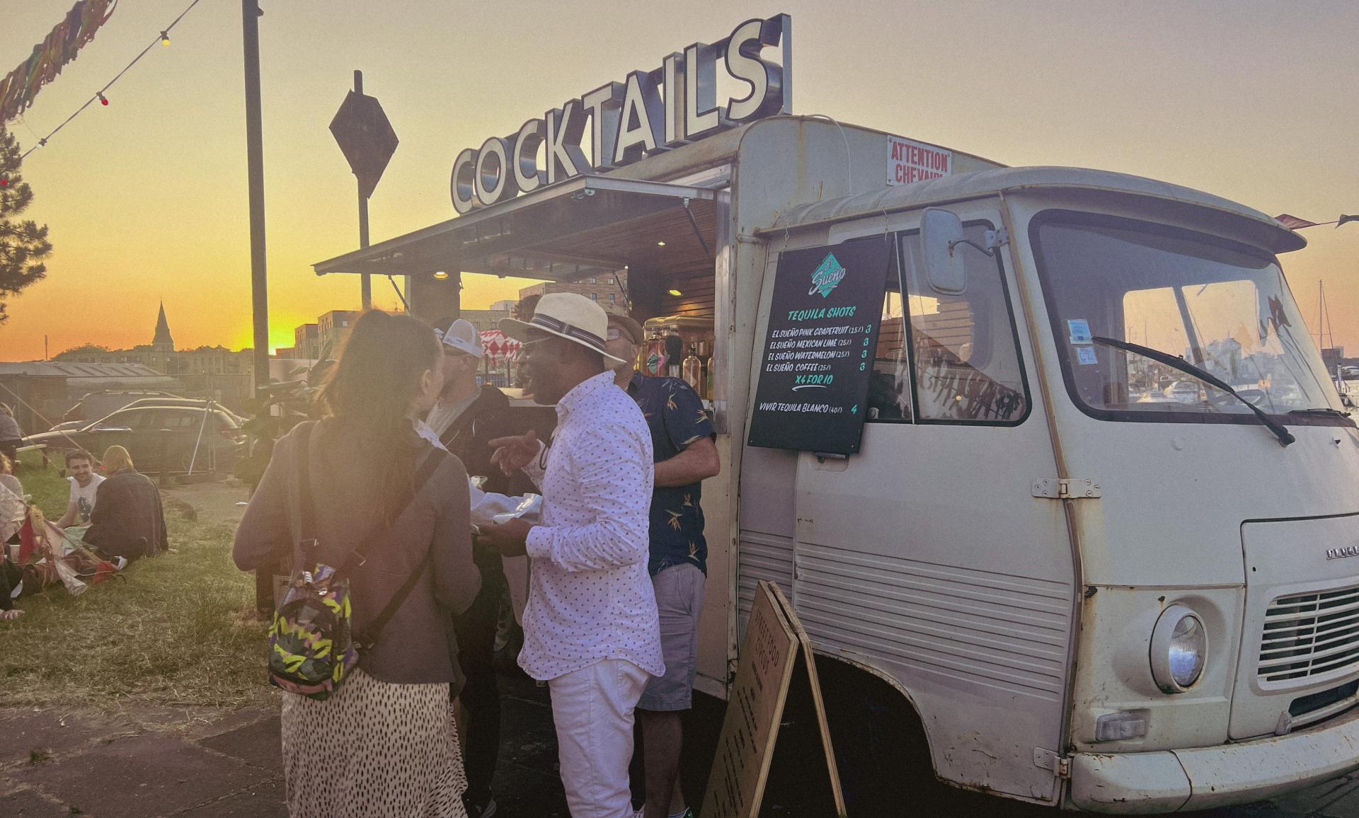 people stood in front of a cocktail vendor van