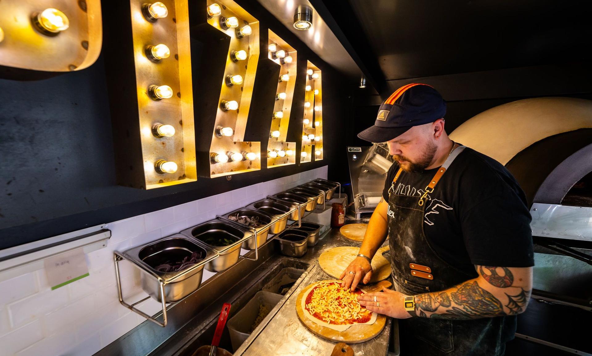 person making a pizza