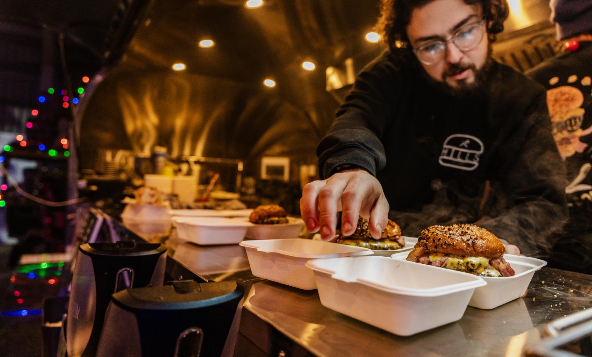 person preparing burgers