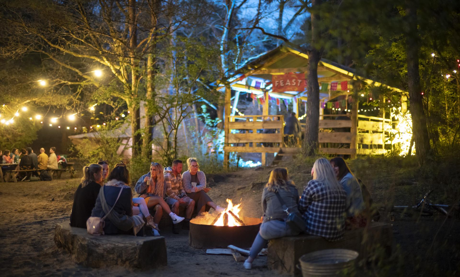 a group of people sat around a fire